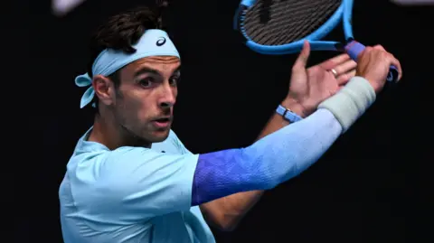 Lorenzo Musetti slices a backhand