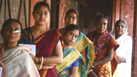 People line up to vote at a polling station during India's general election in Cooch Behar, West Bengal on April 11, 2019.