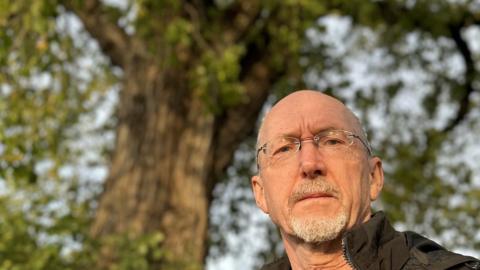 Cllr James Abbott standing next to Witham Elm Tree