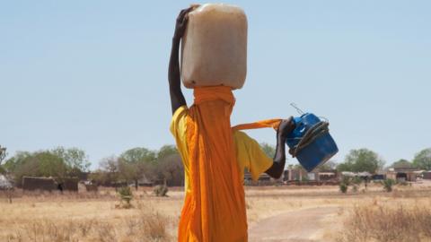 Sudanese woman carrying water