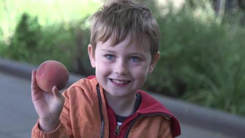 Child with (not giant) peach