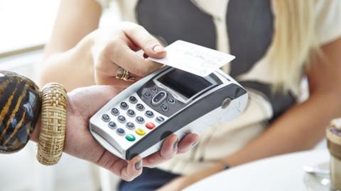 Credit card being used to make a contactless payment