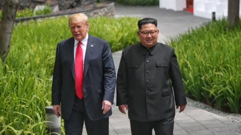 Donald Trump and Kim Jong-un walk beside each other at the Capella hotel in Singapore