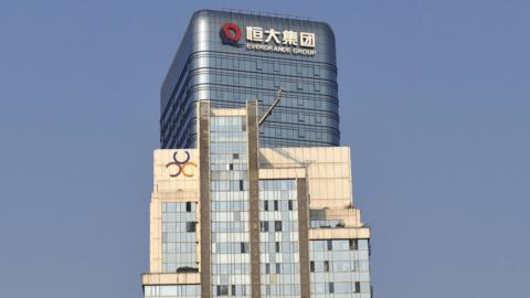 The logo of Evergrande Group is seen on the facade of a commercial building.