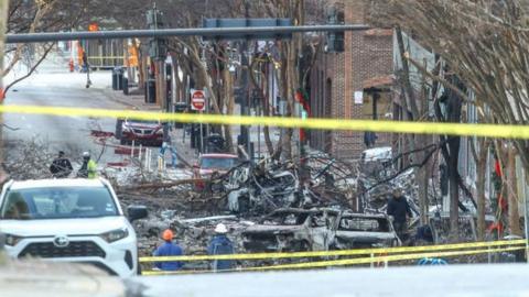Police close off an area damaged by an explosion on Christmas morning