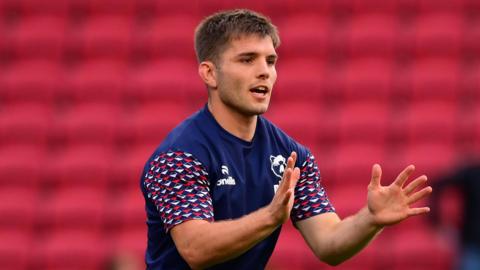 Harry Randall holds his hands out to catch a ball during a pre-game warm-up for Bristol