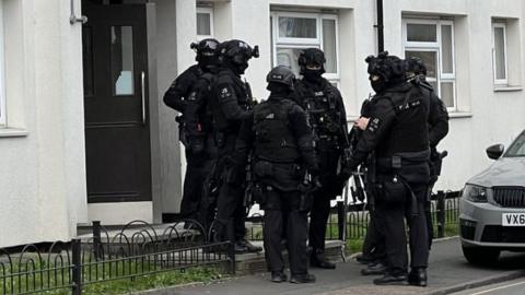 Armed police outside address in Gloucester