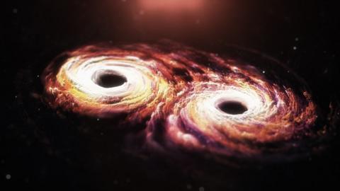 Artist impression: The supermassive black holes at the heart of each galaxy spiral in on each other, sending gravitational shock waves across the Universe
