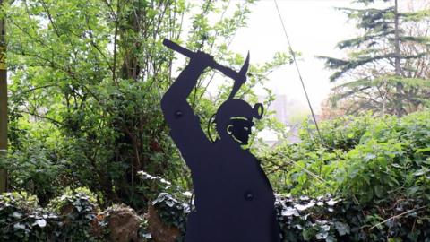 Metal silhouette of a miner