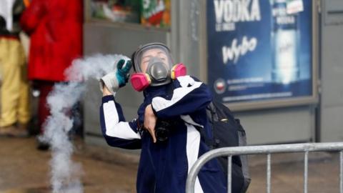 Student throws a tear gas canister in Santiago
