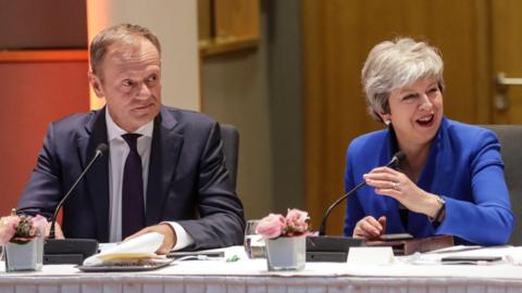 European Council President Donald Tusk (L) and Britain"s Prime Minister Theresa May look on during a European Council meeting on Brexit