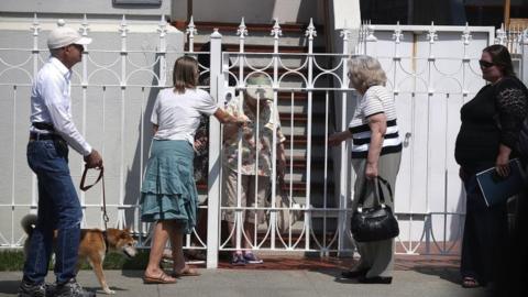 People wait in line to enter the Russian consulate on 1 September 2017 in San Francisco, California.