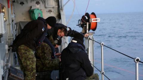 Estonian Navy sailors conduct an undersea communications cable survey after a pipeline and telecoms cable were damaged.