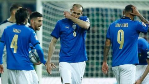 Italy players look dejected after losing their World Cup semi-final play-off to North Macedonia