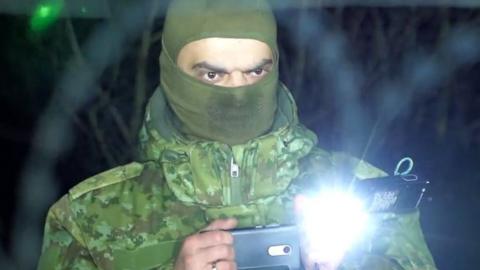 A Belarusian soldier is filmed by Polish authorities while filming at the border