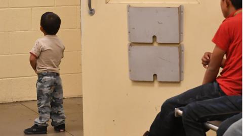 Young migrant boys, whose faces can not be shown, are seen at the US Customs and Border Protection Facility in Tucson, Arizona