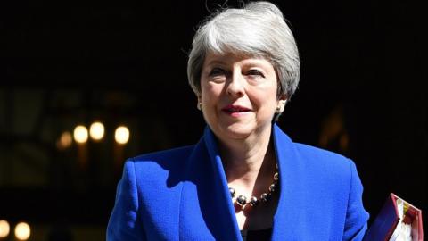 Theresa May dressed in blue