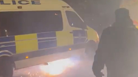 A firework under a police van