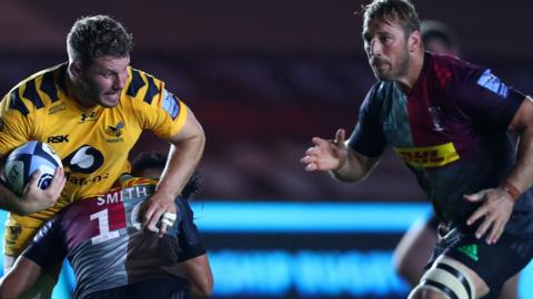 Thomas Young of Wasps is tackled by Marcus Smith