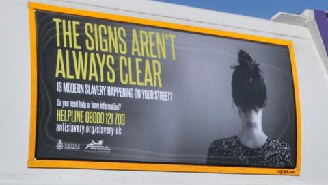 Modern slavery poster on bin lorry