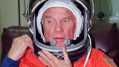 John Glenn suits up at the Kennedy Space Center in Florida prior to his trip to Launch Pad 39-B, 9 October 1998