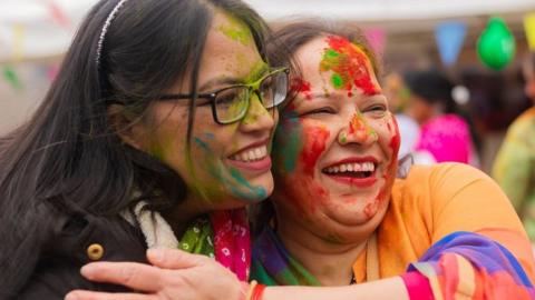 An image of two women at a Holi celebration