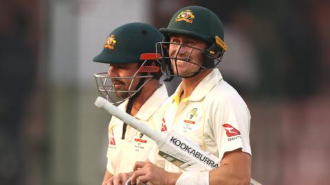 Australia's Marnus Labuschagne and Travis Head walk off at close on day two of the second Test against India