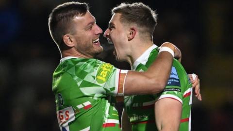 Jack van Poortvliet is congratulated by fellow Leicester half-back Handre Pollard after scoring the opening try at Newcastle