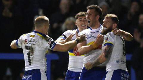 Warrington celebrate a try