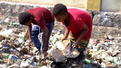 Children rummage for food