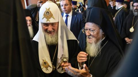 Greek Orthodox Ecumenical Patriarch Bartholomew I (R) and members of the clergy greet Patriarch of Moscow and All Russia Kirill (C) at St George church, the main Greek Orthodox cathedral during his visit on August 31, 2018 in Istanbul.