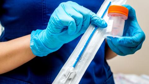 Nurse holds cervical screening brush