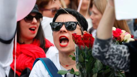 Woman shouts during protest against violence against police