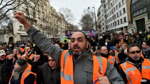 Protesters, including yellow vests and others from different unions, march on Boulevard Diderot towards Place de la Bastille during a protest against the government's pensions overhaul in Paris, France on January 11, 2020