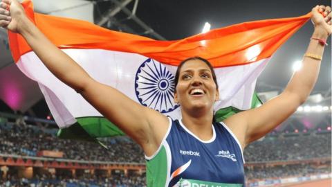 India's Krishna Poonia celebrates her gold medal during the discus women final of the Track and Field competition of the XIX Commonwealth Games on October 11, 2010 in New Delhi.