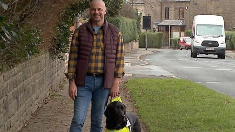 A man with a guide dog