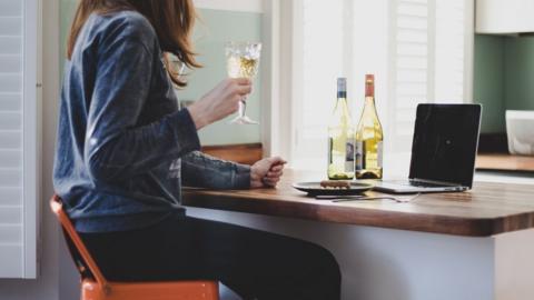 Woman drinking wine at home