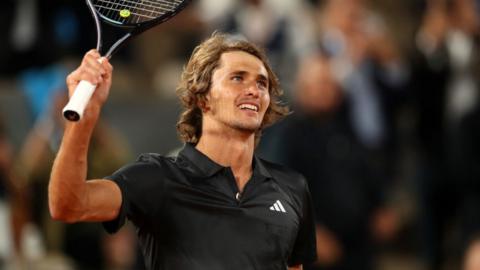 Alexander Zverev raises his racquet to the crowd