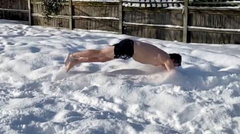 Chris Bell diving into snow