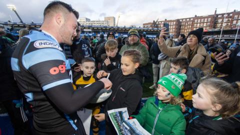 Owen Lane signs autographs for children