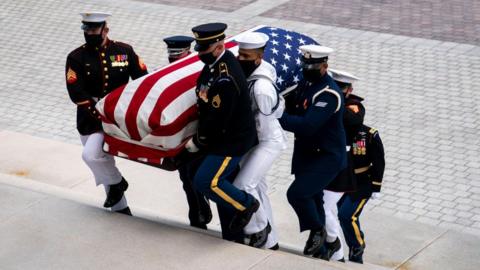 The flag-draped casket of the late Rep. John Lewis, D-GA, is carried by a joint services military honor guard, as he arrives to lie in state in the Rotunda of the US Capitol in Washington, DC, on July 27, 2020