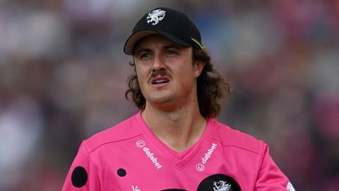 Tom Kohler-Cadmore walking on the field during a T20 match