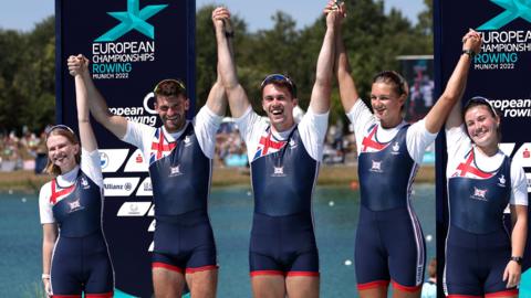 Erin Kennedy celebrates on the medal podium with her crew