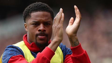 Chuba Akpom applauds fans as he warms up before Middlesbrough's season opener with Millwall
