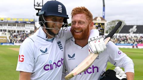 England batters Joe Root (left) and Jonny Bairstow (right) embrace as they walk off after beating India