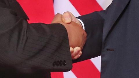 Close up of handshake between Trump and Kim