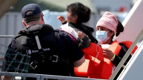 A group of migrants, including children, are brought to Dover on Thursday 3 June