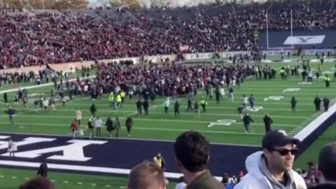 Protesters on the football pitch of a Harvard-Yale game