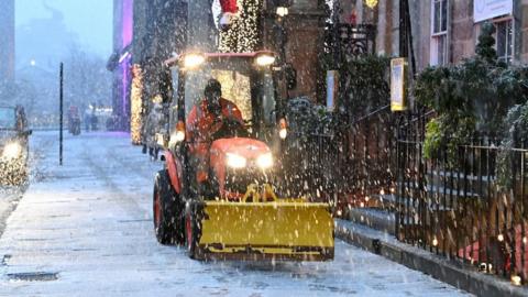 A snow plough clears the snow during Storm Bert, along George Street in Edinburgh