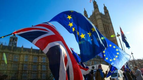 The UK and EU flags outside the Palace of Westminster